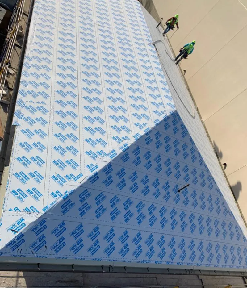 Professional roofers installing underlayment on a metal roof in Upper Freehold